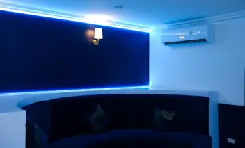 Versailles Nuru Massage Pattaya: blue-lit room with curved sofa